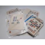 A large quantity of all-world stamps on loose album sheets