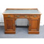 A leather inset twin pedestal mahogany desk with wooden gallery, W123 x D54 x H76cm