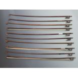 Ten round stick violin bows with three part buttons, mother of pearl eye to frogs