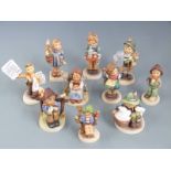 A collection of Goebel Hummel figures including Newspaper Vendor, tallest 14cm