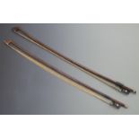 Two cello bows, one with three part button and plain mother-of-pearl eye to frog, 78.6g, the other