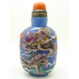 Chinese glass scent bottle with raised enamel dragon decoration and four character mark to base,