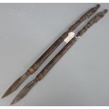 Pair of African or possibly Dayak, Borneo carved hardwood slashing or skinning knives with branded