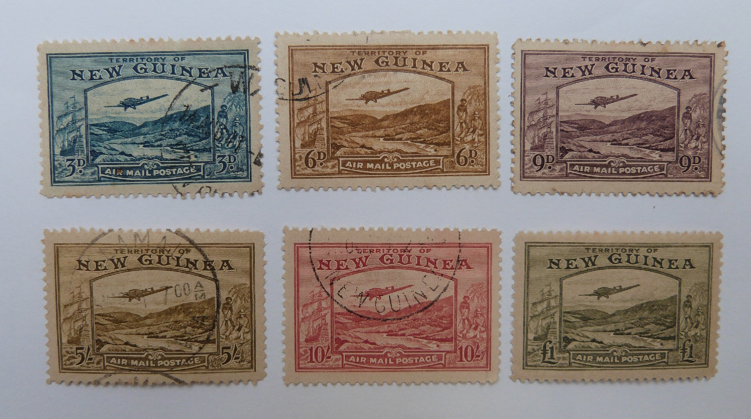 New Guinea 1939 part set light used stamps including 5s and 10s (SG 223 and 224). Also £1