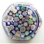 Peter McDougal millefiori paperweight on blue ground with cut facets, 5.5cm diameter