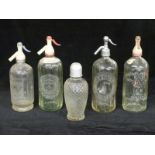 Five vintage soda siphon bottles including W Biscombe Plymouth, Cambrian Mineral Water Co Bolton,