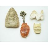 Chinese agate carving of a monkey, an ivory netsuke of a man/devil and a stone carving of Guanyin
