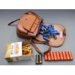 A collection of 12 bore shotgun cartridges together with a leather cartridge bag. PLEASE NOTE THAT A