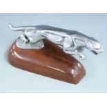 Jaguar car mascot on wooden display base, length 20cm