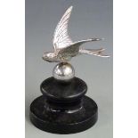 Vintage car mascot formed as a bird with sphere below, on ebonised base, overall height 11.5cm