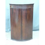 19thC bow fronted inlaid mahogany corner cupboard, W65 H100cm