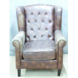 A contemporary faux leather Chesterfield wing back armchair, H98cm