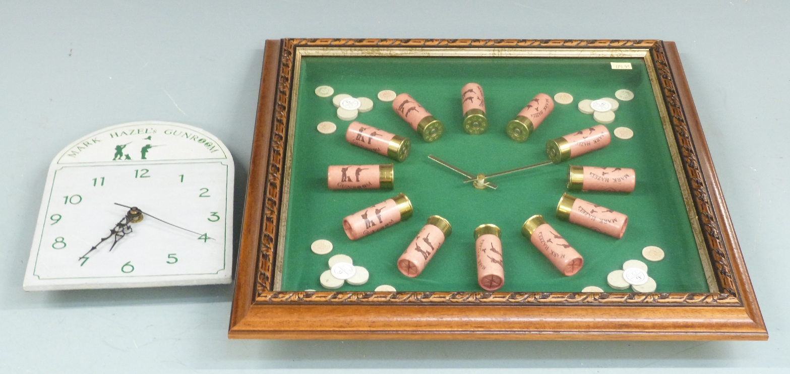 A shotgun cartridge display case in the form of a clock with each cartridge marked Mark Hazel's,