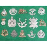 A small collection of British military cap badges including Royal Sussex Regiment, The King's Own