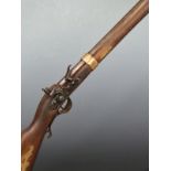 Kentucky style flintlock hammer action rifle with ornate brass storage compartment to the lock,
