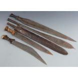 Five 19thC African tribal machetes and short swords including one with a turned wooden handle and