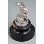 Desmo vintage car mascot formed as a seated rabbit, on ebonised base, overall height 12.5cm