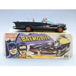 Corgi Toys diecast model Batmobile 1st type with no tow hook, black body, figures and bat logo hubs,