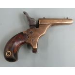 Deactivated percussion hammer action .22 pocket or muff pistol with brass body, shaped mahogany