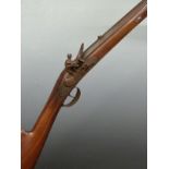 Unnamed flintlock hammer action gun with engraved lock and trigger guard, brass tipped wooden ram-