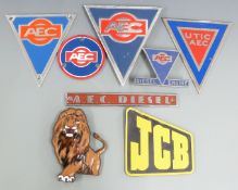 Various commercial vehicle badges including AEC, enamel lion badge height 13.5cm, and JCB logo