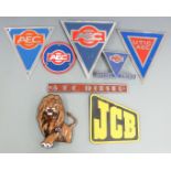 Various commercial vehicle badges including AEC, enamel lion badge height 13.5cm, and JCB logo