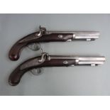 A pair of percussion hammer action pistols with engraved locks, hammers, trigger guards and top