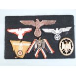 Six German Third Reich Nazi badges mounted on card