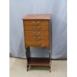 A mahogany music or filing chest of five drawers with undershelf, drawers with hinged drop action