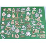 Over 60 British Army cap badges and shoulder titles for cavalry regiments including Royal