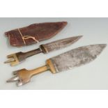 Two 19thC North African tribal knives with horn handles and brass or steel finials, longest 39cm