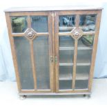 Art Nouveau glazed oak bookcase with adjustable shelves, W106 D30 H129cm