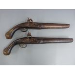 A pair of flintlock hammer action pistols with brass wire inlaid decoration, embossed brass