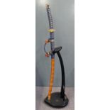Japanese Samurai sword with gilt fittings and blue rope binding, overall 105cm on display stand