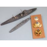Three Russian badges together with two Royal Navy models of ships