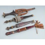Four African tribal daggers, each with leather scabbard and shaped handle, longest 31cm