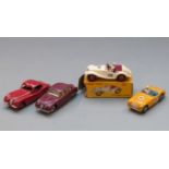 Four Dinky Toys diecast model cars comprising MG Midget Sports with white body, red interior and