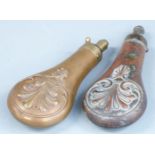 Two copper and brass powder flasks both with embossed decoration to both sides, largest 20.5cm long.