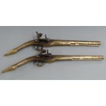 Pair of Albanian brass flintlock rat tail miquelet pistols each with all over engraving, studded