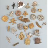 A small collection of cap badges including Lancashire Volunteers, Glider Pilot Regiment,