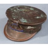 A brass trench art officer's cap with Royal Artillery motif, diameter 5cm