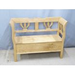 A contemporary pine settle with hinged seat, W120 D42 H91cm