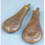 Two copper and brass powder flasks, one Dixon & Sons, both with embossed decoration to each side,