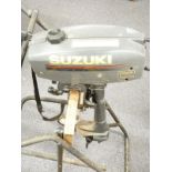 Suzuki 2 Horsepower outboard motor boat engine on wheeled stand