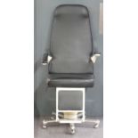 An optician's/barber's or therapist's chair with adjustable arms and footrest raised on castors,
