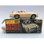 Corgi Toys diecast model James Bond 007 Aston Martin DB5 with gold body, red interior, spoked hubs