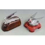 Two Wolseley car mascots, one on radiator cap, both on wooden bases, overall length of larger 13cm