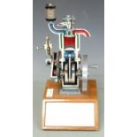 Demonstration educational model 4 stroke diesel engine on base with annotated diagram of engine to