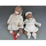 Two Ashton Drake Galleries Reborn silicone dolls one with closed mouth, blue eyes and black hair,