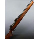 Ruger M77 7x57 bolt-action rifle with chequered semi-pistol grip, sling suspension and scope